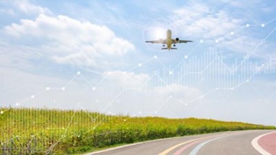 Plane flying over green pastures